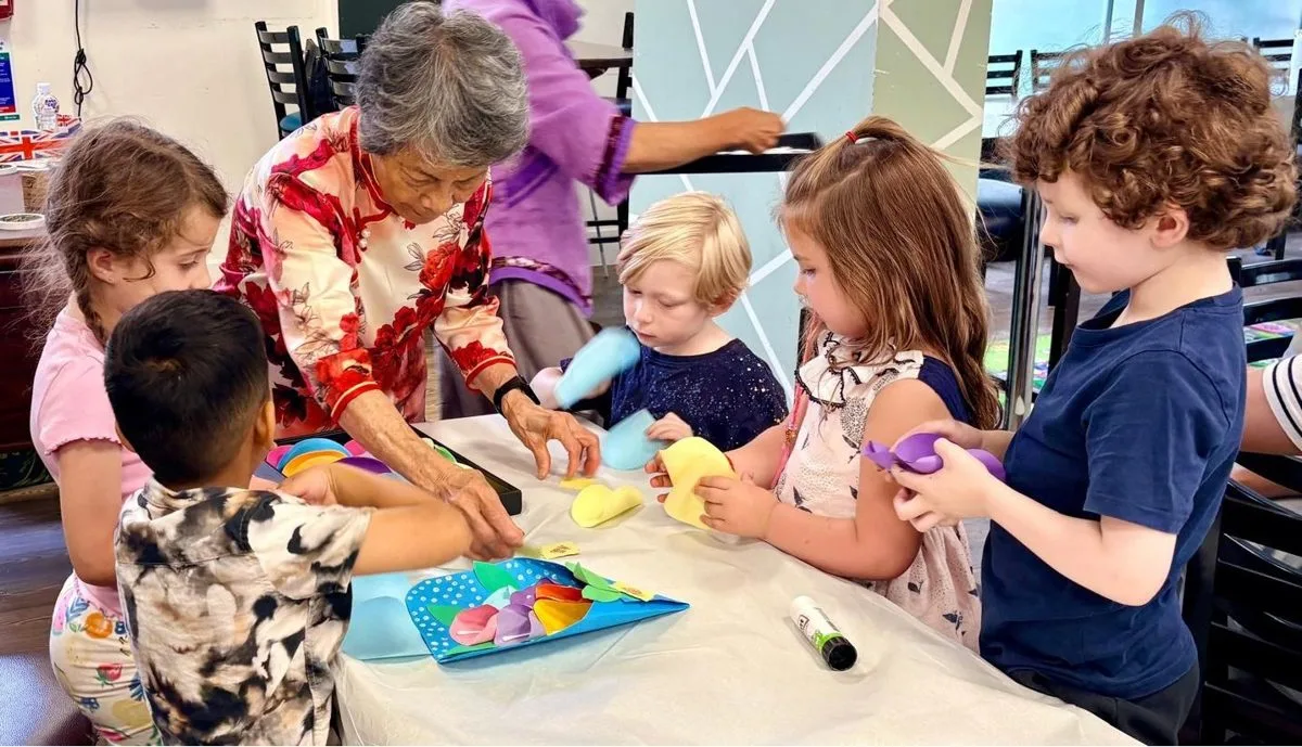 Children making paper flower bouquets at the Chinese Stories Arts and Crafts workshop