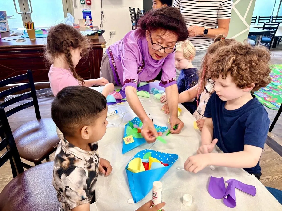 Children making paper flower bouquets at the Chinese Stories Arts and Crafts workshop