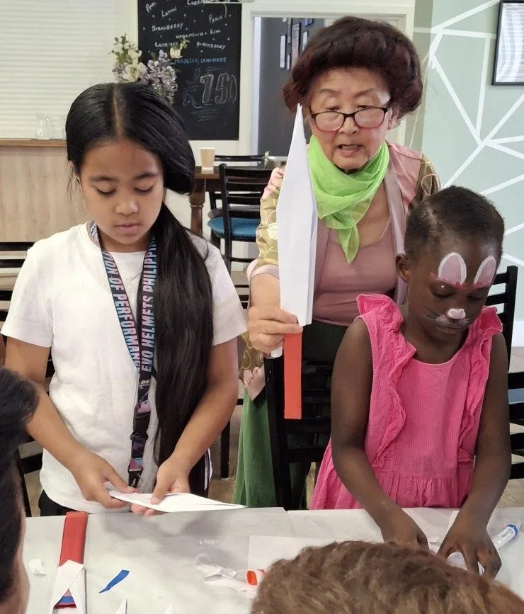 Children making card swords and learning the Chinese Sword Dance
