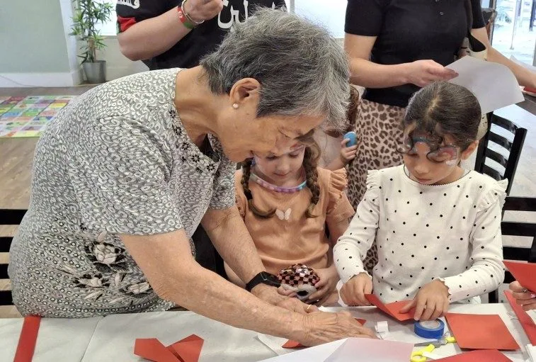 Children making card swords and learning the Chinese Sword Dance