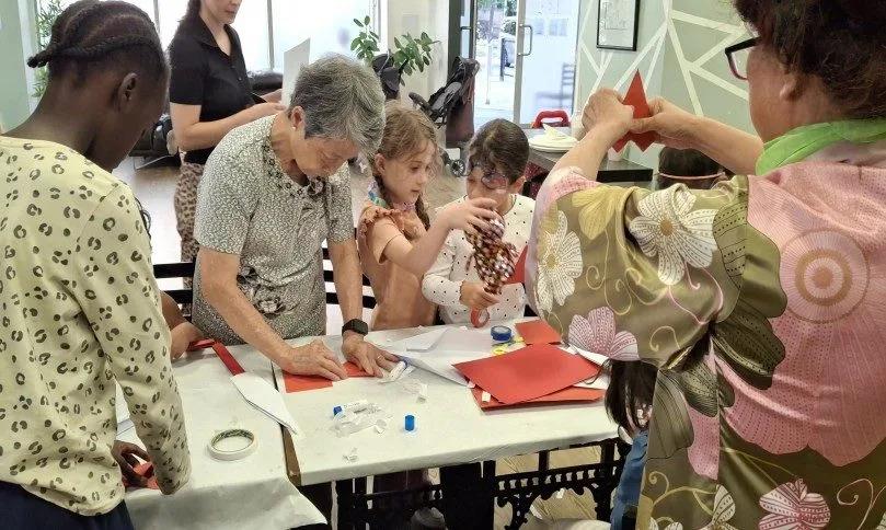Children making card swords and learning the Chinese Sword Dance